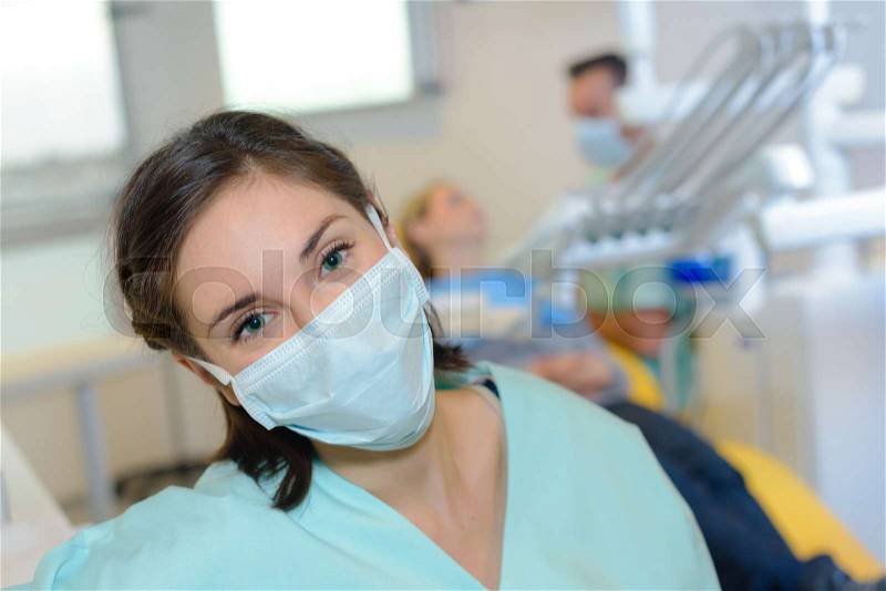 Portrait of dental nurse wearing mask, stock photo