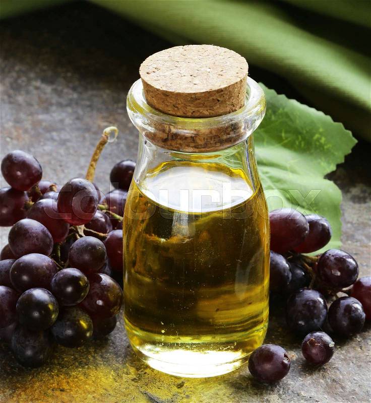Natural organic grape seed oil in a glass bottle, stock photo