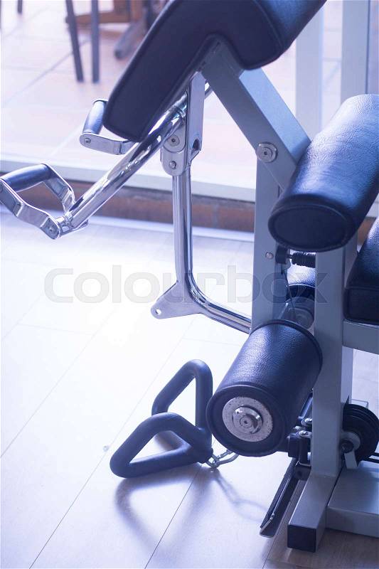 Gym exercise weight training bicep curl resistance machine in fitness studio used to increase strength and build biceps muscle, stock photo