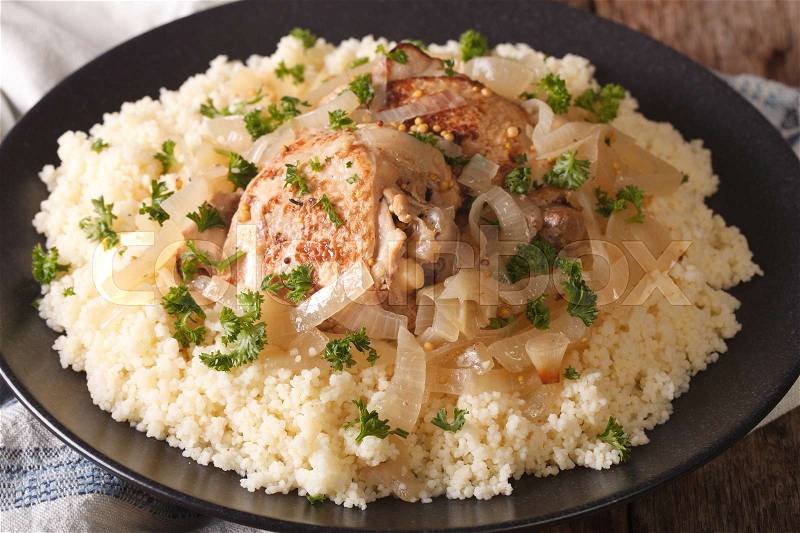 West African food: Chicken Yassa and couscous with onions on a plate macro. horizontal , stock photo