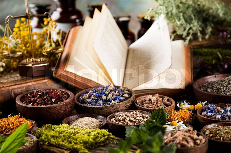 Book and Herbal medicine on wooden table background, stock photo