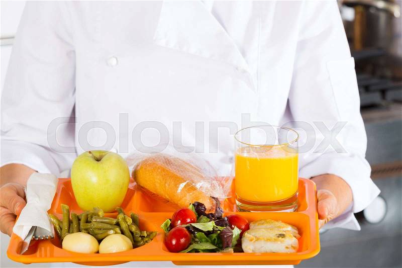 Cook in a school with a tray of food, stock photo