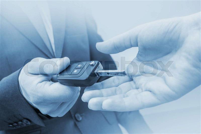 New Car Delivery Concept. Car Salesman Delivering New Vehicle. Giving New Car Keys. Blue Color Grading, stock photo