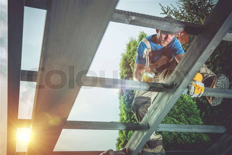 Pro Carpenter at Work. Wood Construction Job, stock photo