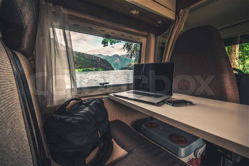 Work and Travel Concept. Laptop Computer on the Motorhome Table. Working While Traveling. Internet Connection While RVing, stock photo