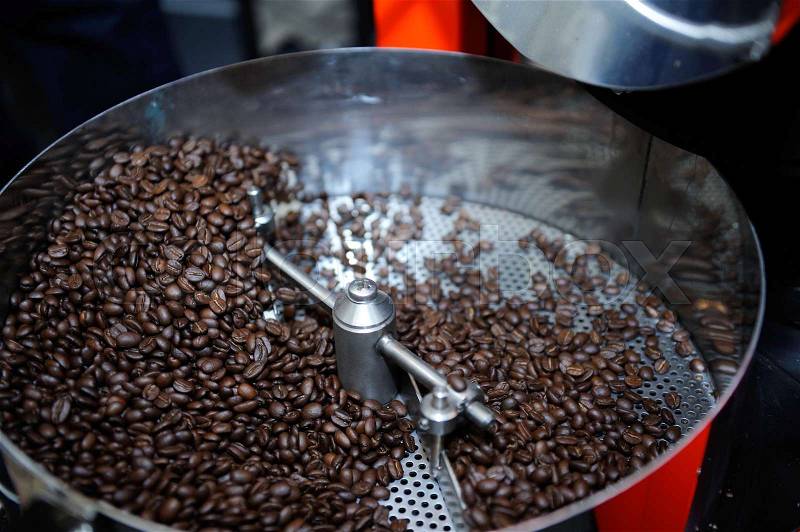 Freshly roasted coffee beans in a coffee roaster, stock photo