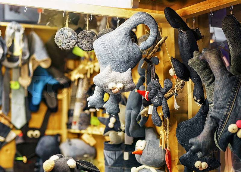Black cat toys made of textile hanging at the stall during the Christmas market in Riga, Latvia. Selective focus, stock photo