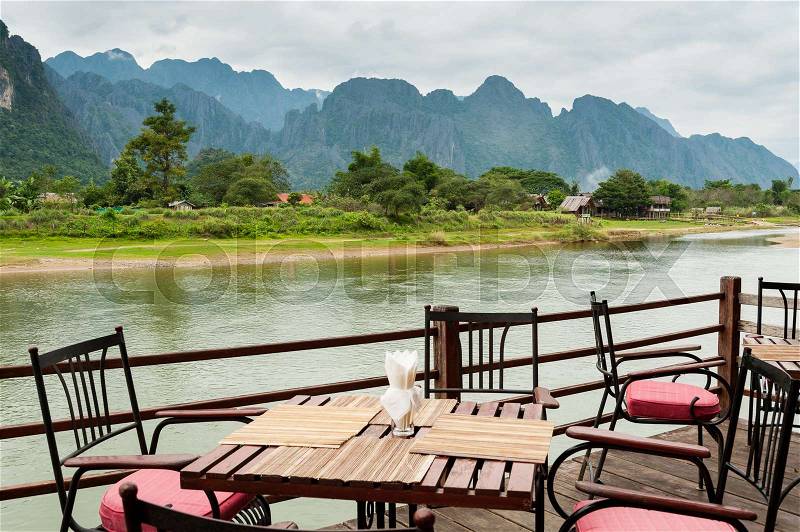 View of Nam Song River with Dining Table at Vang Vieng, Laos, stock photo