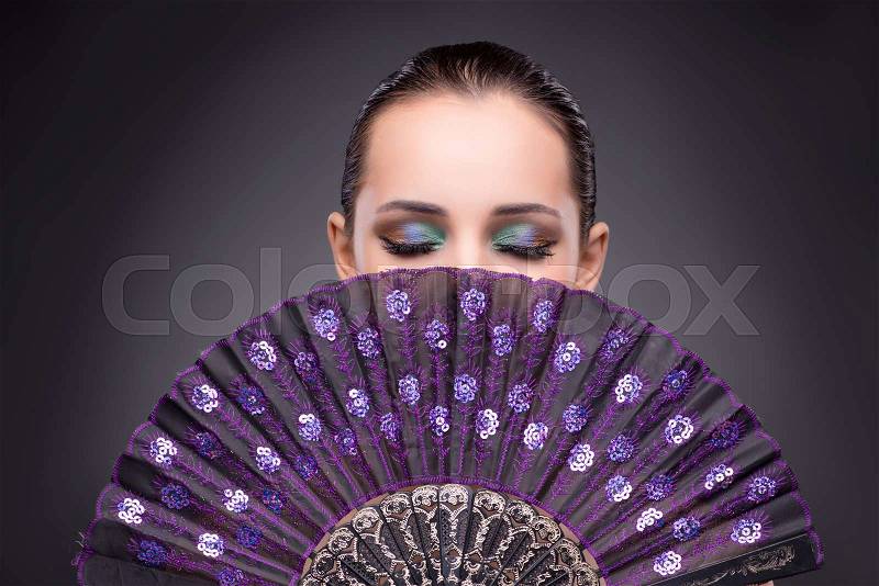 Beautiful woman with fan in fashion concept, stock photo