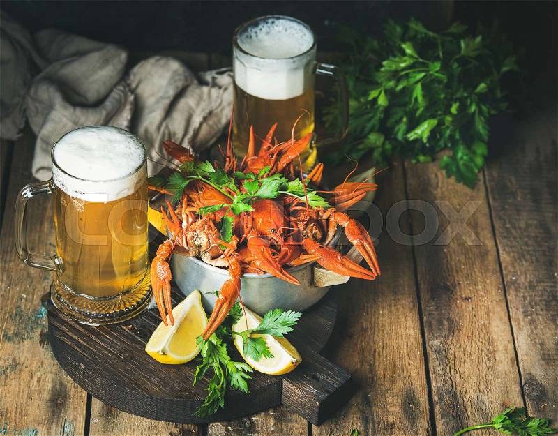 Wheat beer and boiled crayfish with lemon, fresh parsley, stock photo