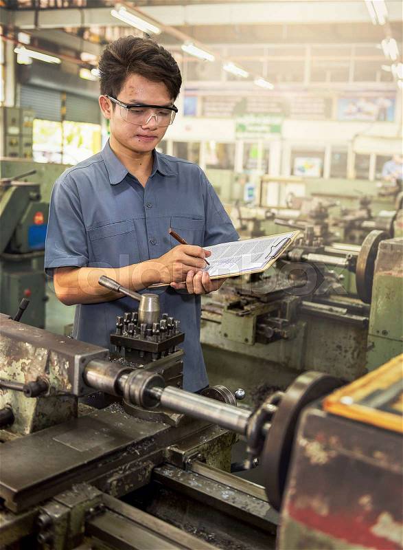 Factory worker writing report\, stock photo
