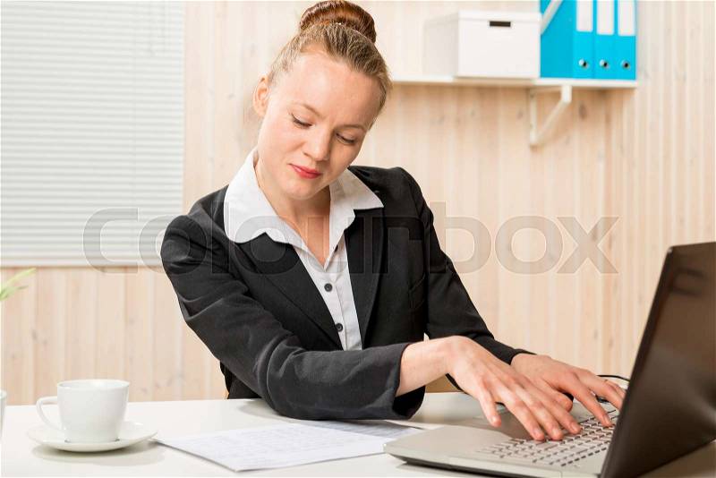 Secretary prints the text of the document on the laptop , stock photo