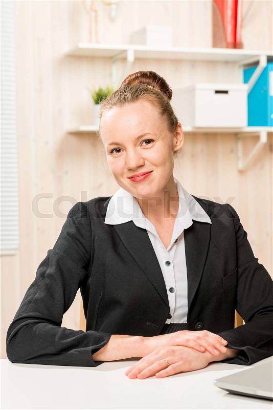 Happy company accountant posing at his desk in the office , stock photo