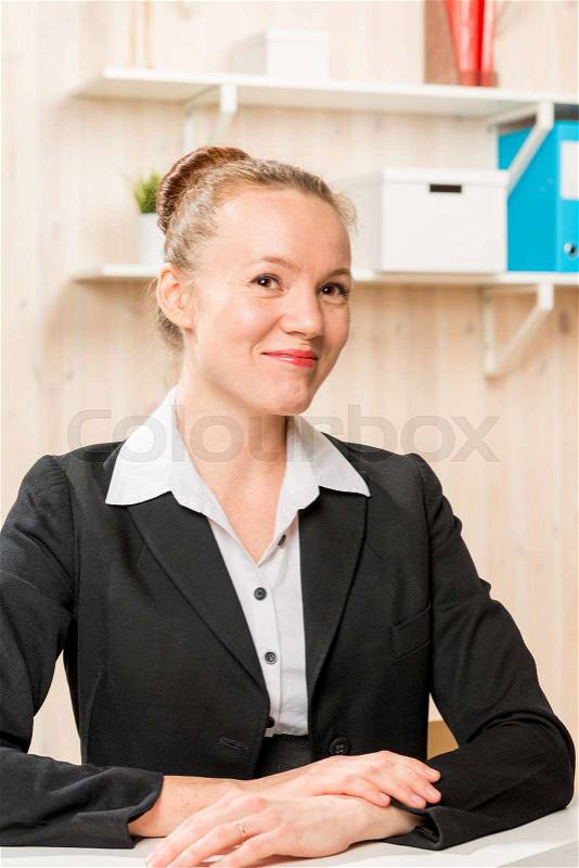 Cute girl a company representative with a beautiful smile in the office, stock photo