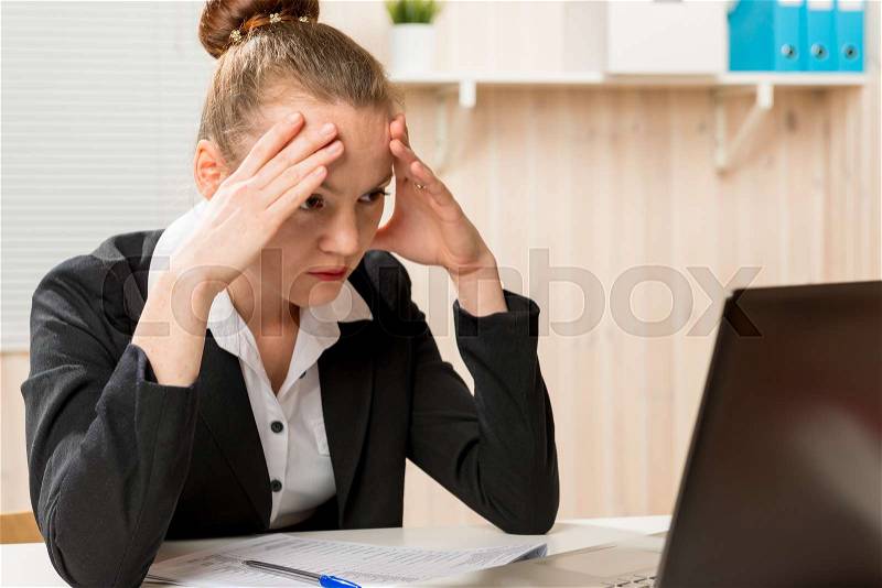 Tired woman financial analyst looking for a mistake in the reports, stock photo