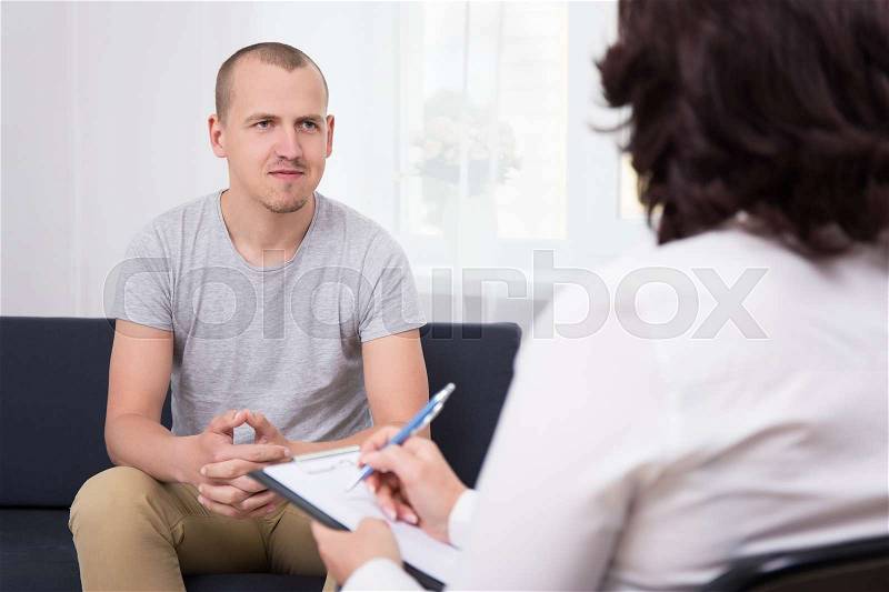 Happy handsome young man at interview in office, stock photo