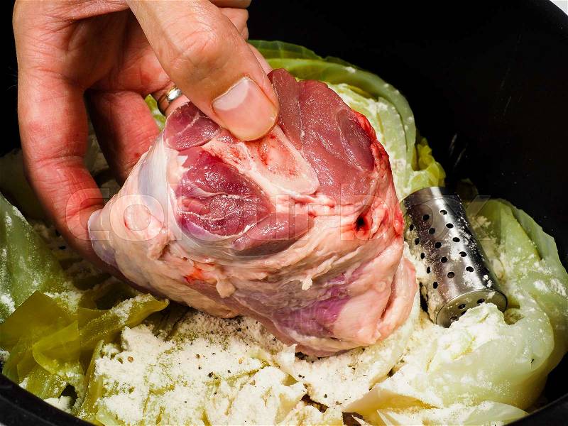 Chef preparing a traditional norwegian dish, lamb and cabbage with peppercorns, stock photo
