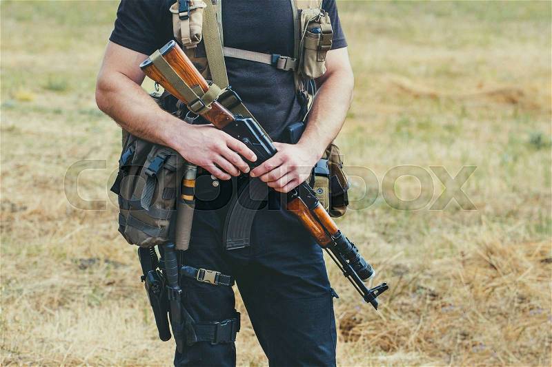Soldier with a gun in the hands of the patrol area, stock photo