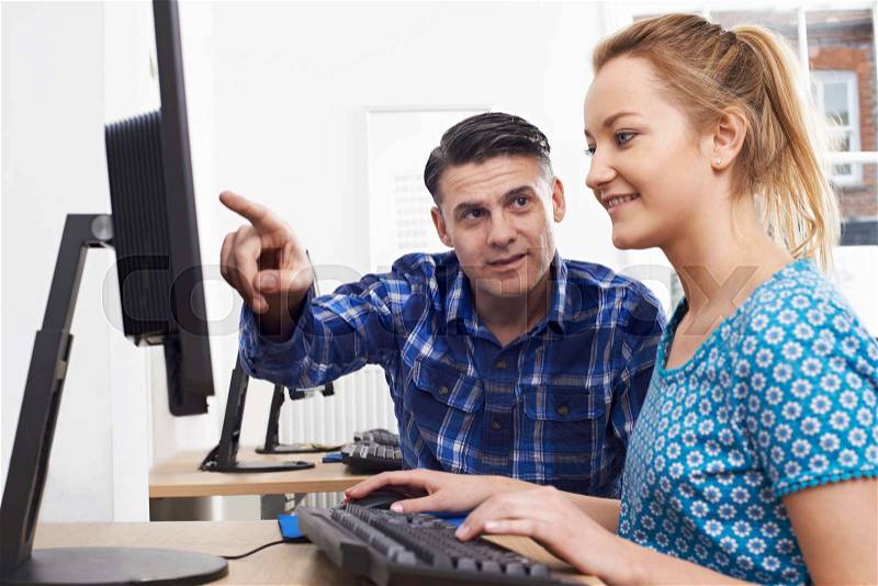 Man Training Woman On Computer In Office, stock photo