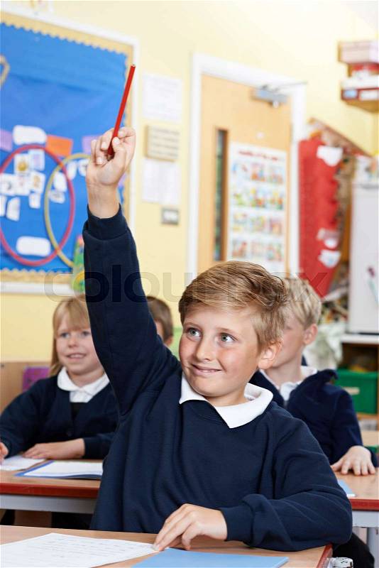 Elementary School Pupil Answering Question In Class, stock photo