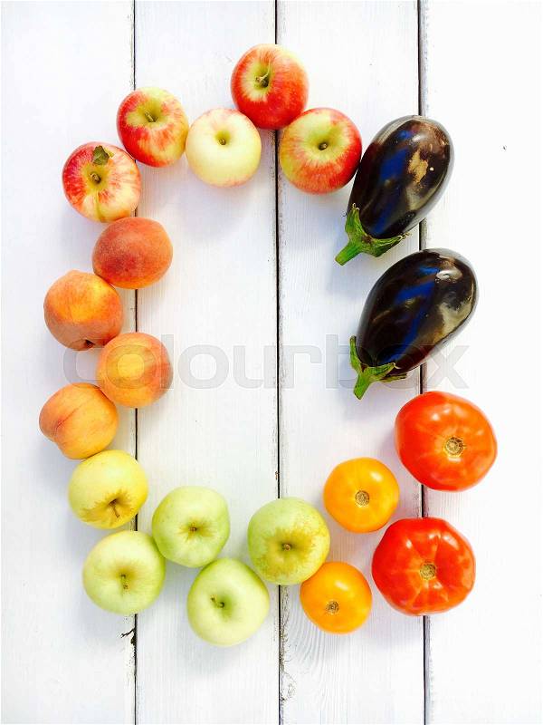 Variety of fresh summer fruits and vegetables - apples, peaches, tomatoes and eggplants. Copy space for your text, stock photo