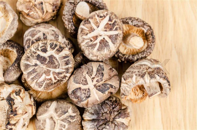 Dried shiitake mushrooms on wooden background, stock photo