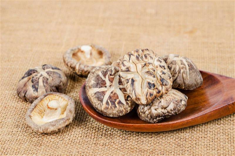 Dried shiitake mushroom on sack background, stock photo