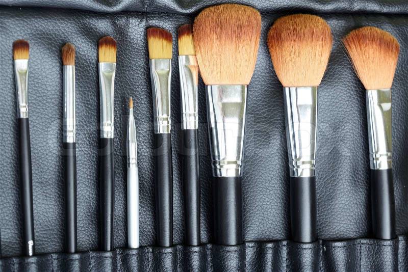 Set of makeup brush in leather cover. Close-up photo, stock photo