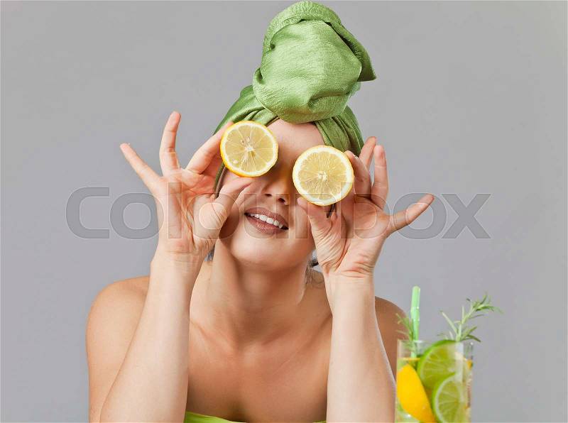 Young woman with lemon and drink from citrus, stock photo