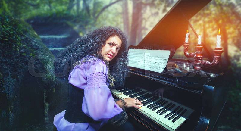 Mystic woman playing the piano in the forest, stock photo