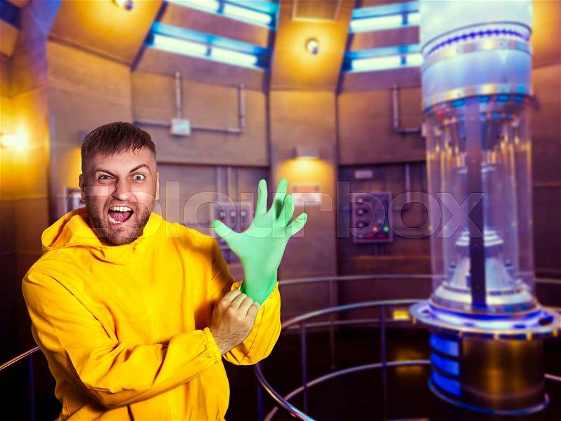 Man in protective suit putting on a rubber glove, stock photo