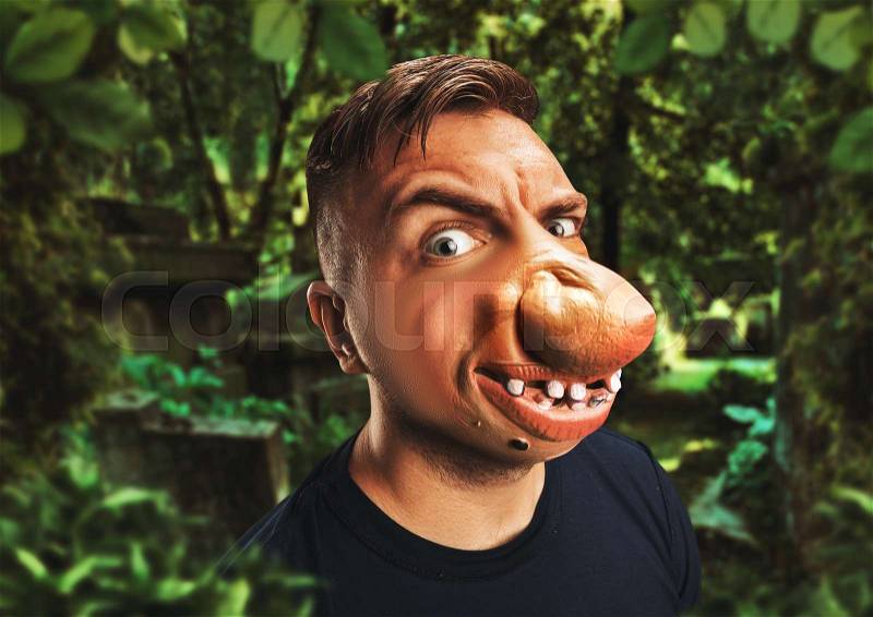 Man with an ugly face in the forest, stock photo
