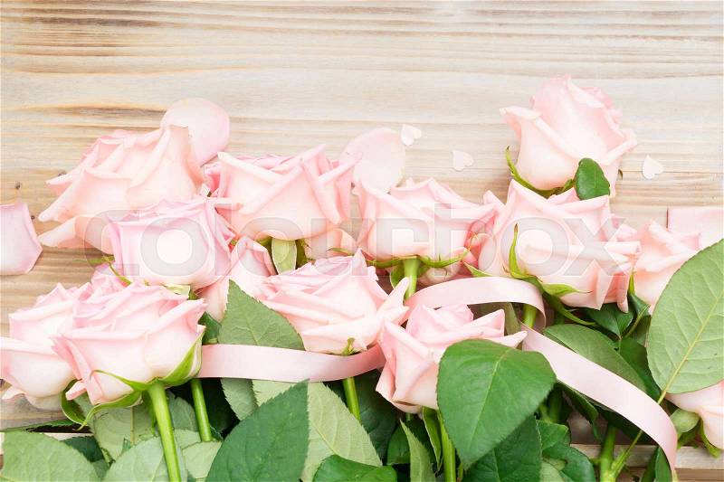 Pink blooming valentines day roses border on wood, stock photo