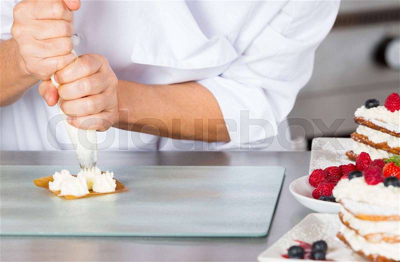 Cream filling pastry chef on a puff pastry, stock photo