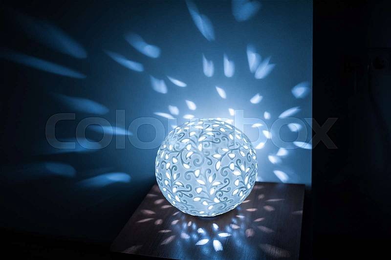 Included lamp ball on table in kitchen with blue light, stock photo
