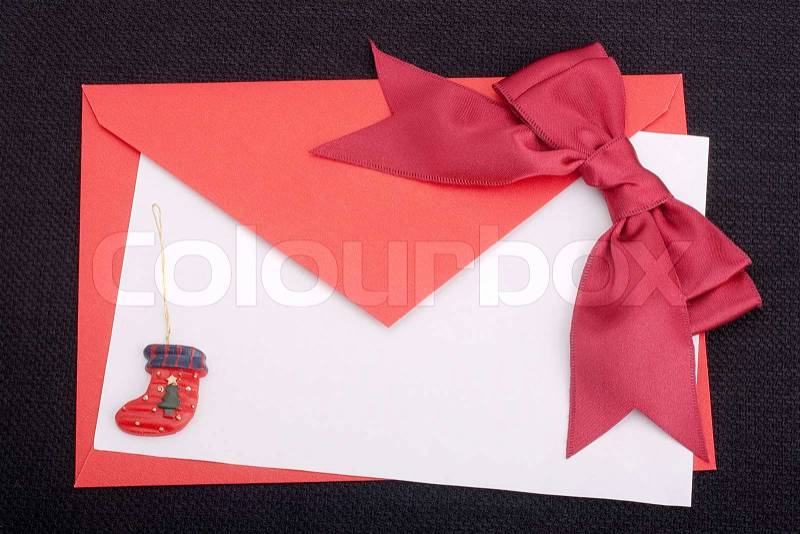 Congratulatory letter with a red envelope and a scarlet ribbon, stock photo