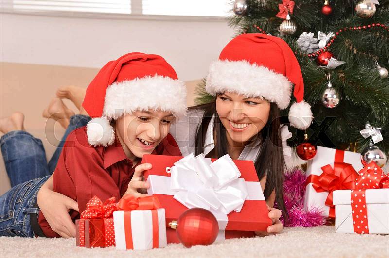 Cute mom and son in santa hats, stock photo