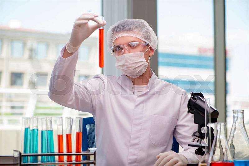 Man working in the chemical lab on science project, stock photo