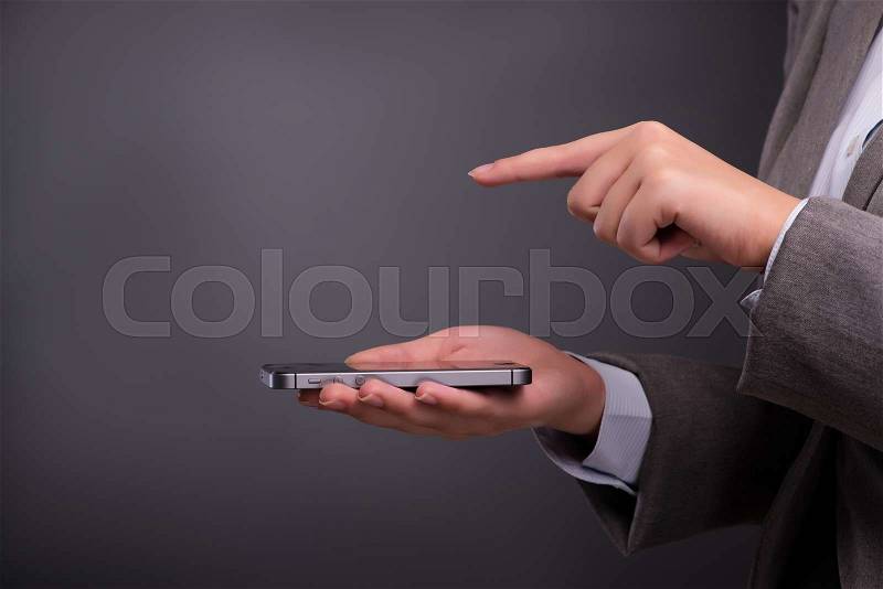 Businesswoman texting and sending text messages, stock photo