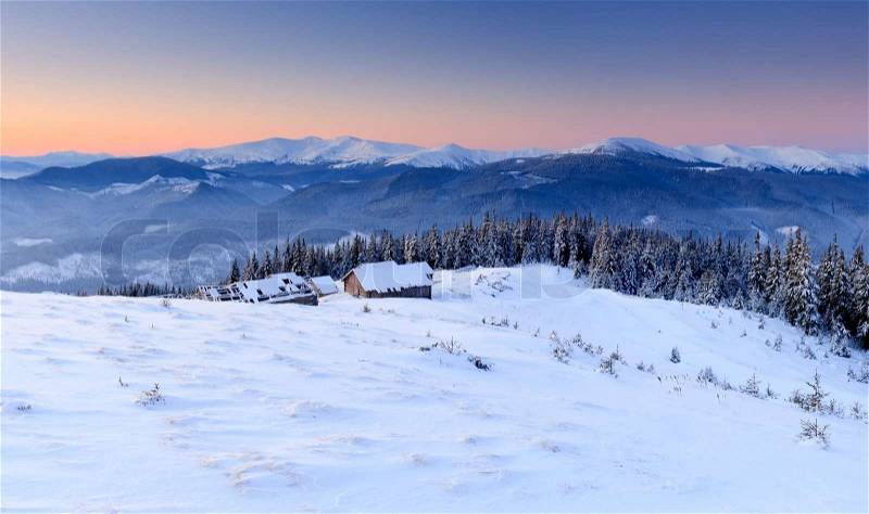 Sunrise in the mountains in winter on a cold morning. Mountain house, stock photo