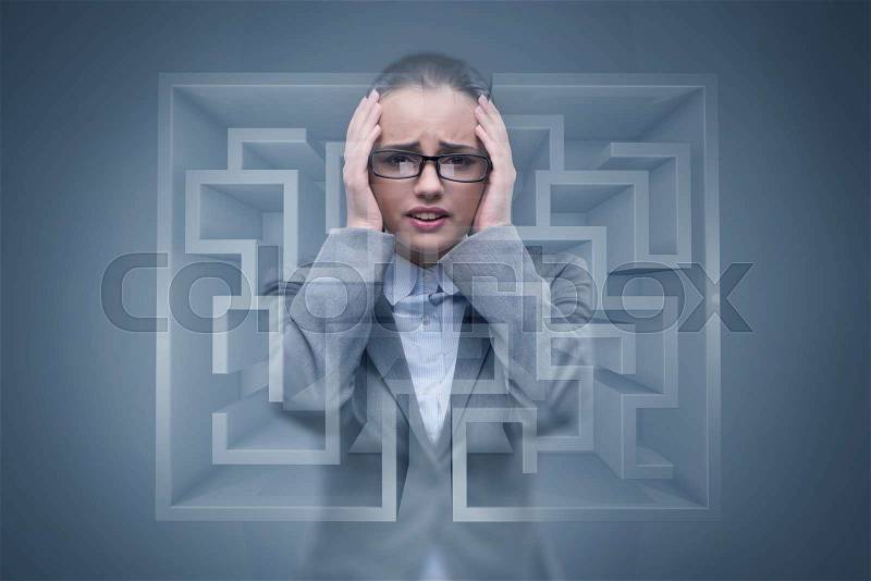 Sad businesswoman lost in maze, stock photo