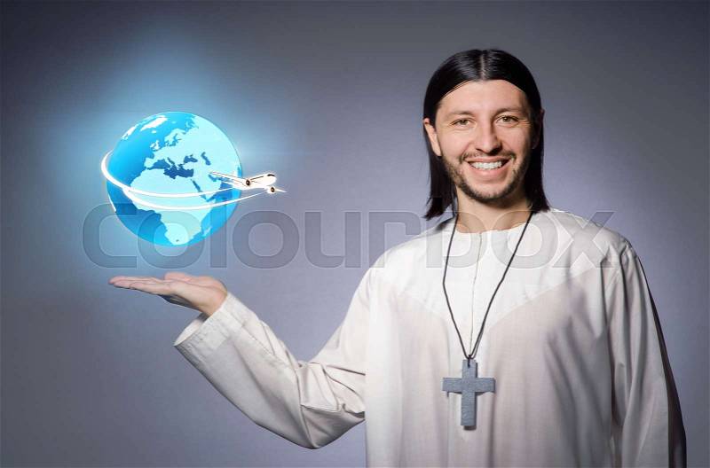 Young christian priest in air travel concept, stock photo