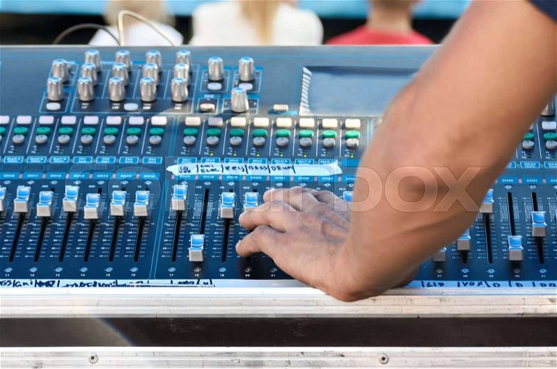 Sound technician adjusts the sound in professional equipment, stock photo