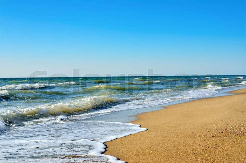 Tidal wave on a clean, sandy, sea beach, stock photo