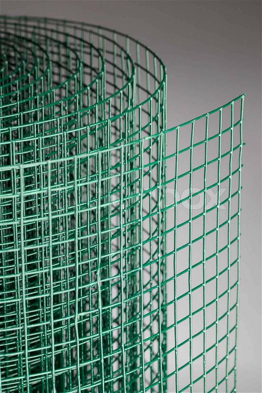 Coated green metallic wire mesh used in gardening by protecting plants from animals, stock photo