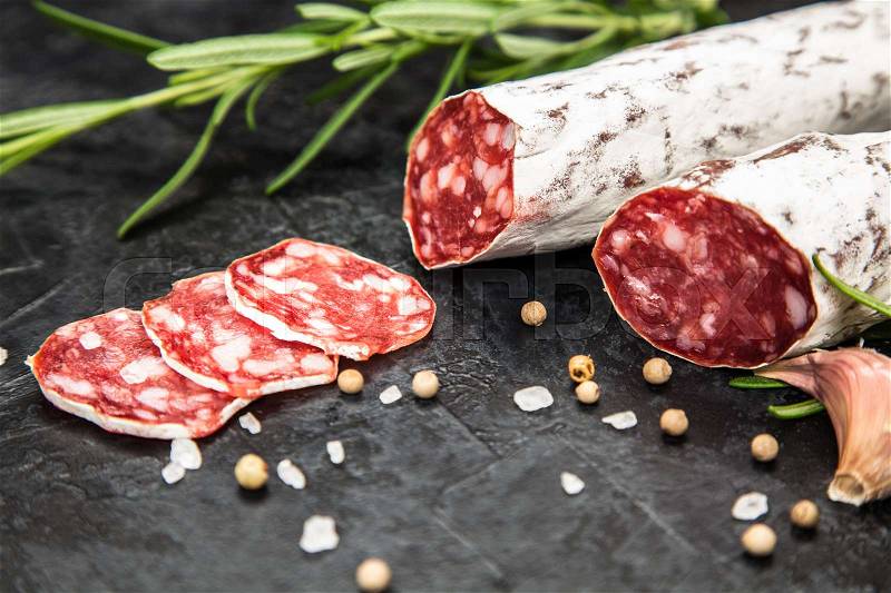 Traditional italian salami on dark background, stock photo