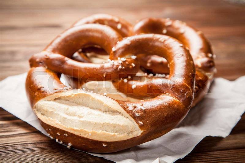 Traditional german pretzels on wooden table, stock photo