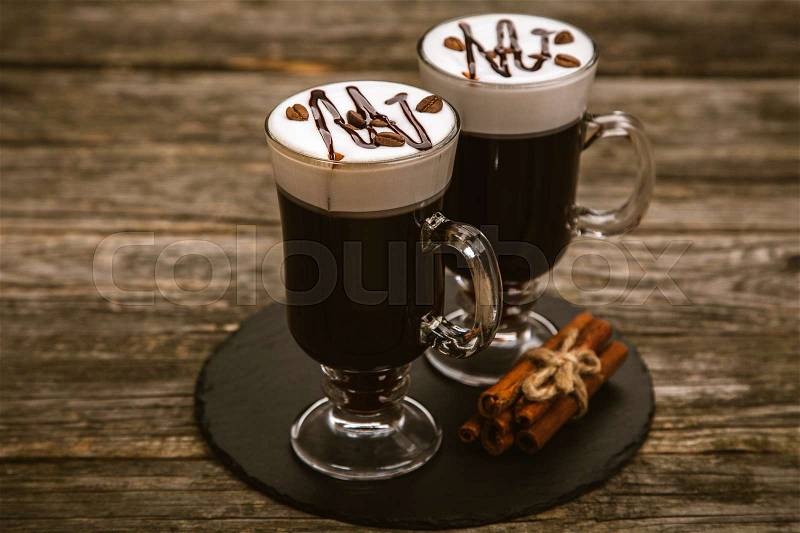 Hot Irish coffee with whiskey and cream, stock photo
