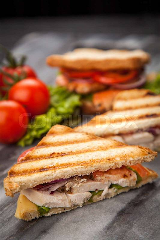 Grilled chicken sandwich with yellow cheese and vegetables, stock photo
