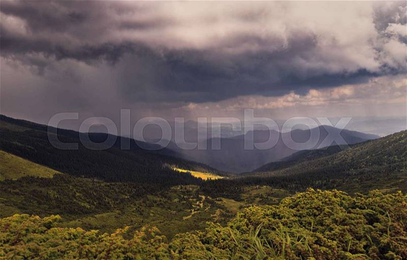 Rain and sun in the mountains. Panorama, stock photo